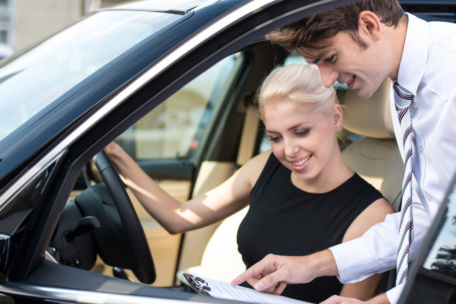 Person standing by their car, suggesting ownership and sharing
